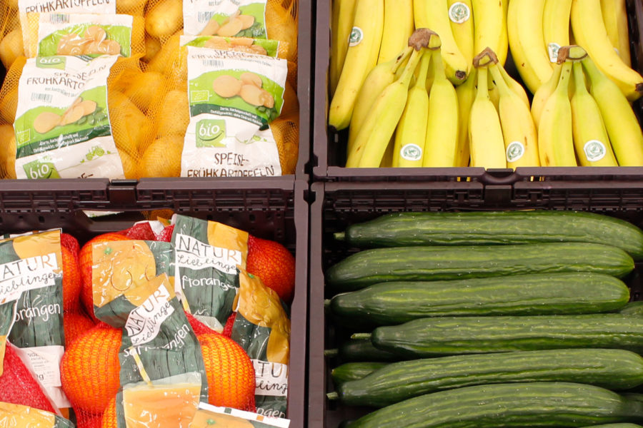 With fruit and vegetables filled boxes